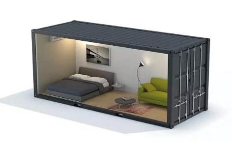 Conteneur maritime aménagé en espace de vie : coin nuit, coin salon et rangements.